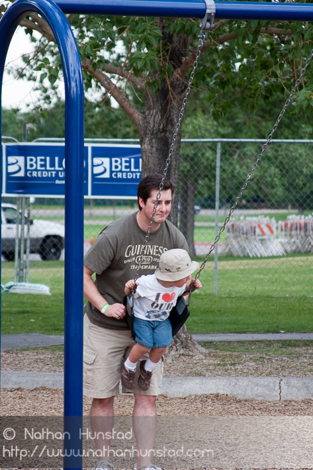 Chris and Michael Weber playing on the swings at the Colorado Irish Festival